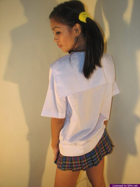 Asian schoolgirl amateur Lily shows her shaved pussy and small tits