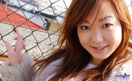 Platinum Asian babe Yumi displays her tiny tits and ass in a solo striptease