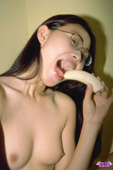 Amateur Asian girl with tiny tits toying her pussy in the kitchen